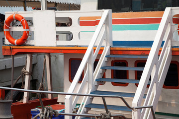 Colorful wooden boat deck with life buoy. Happy ship cruise background