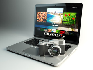 Photo camera and laptop with image viewer on the screen. Digital