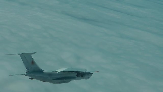 The plane in the turn above the clouds