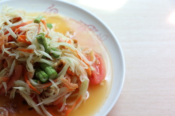 Papaya salad, Som Tam Thai very delicious and spicy in the white plate 