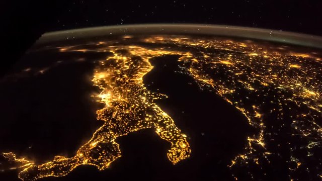 Earth at night from ISS. Elements of this video furnished by NASA. Italy lit night lights