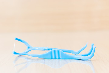 Oral Device : Dental floss on wooden background