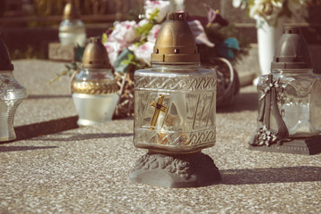 Votive candles lantern on the grave in Slovak cemetery. All Saints' Day. Solemnity of All Saints. All Hallows eve. 1st November. Feast of All Saints. Hallowmas. All Souls' Day