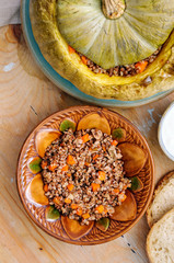 Tasty autumn stuffed pumpkin with buckweat and mushrooms