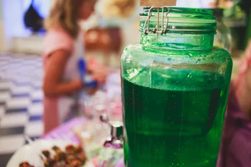 Fototapete Buffet Beautifully decorated multicolored banquet catering with candy bar bar dessert table with different sweet on kids birthday party with children around  © tsuguliev