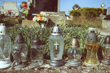 Votive candles lantern on the grave in Slovak cemetery. All Saints' Day. Solemnity of All Saints. All Hallows eve. 1st November. Feast of All Saints. Hallowmas. All Souls' Day