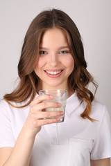 Model holding glass of milk. Close up.White background
