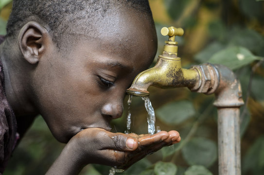 Little African Boy Drinking Healthy Clean Water from Tap