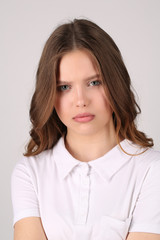 Fototapeta premium Model with serious face in T-shirt. Close up. White background
