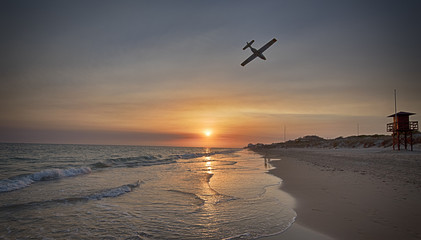 Avión maqueta sobrevolando la playa