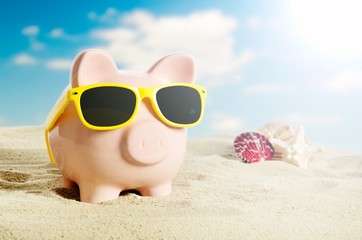 Fototapeta na wymiar Piggy bank on vacation. Concept of holidays economy