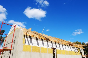 New residential construction home framing against a blue sky. Roofing construction. installation of...