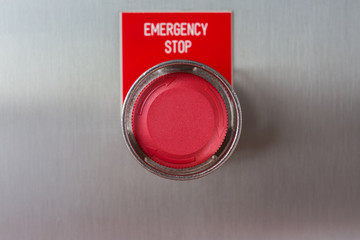 Emergency stop push button switch of gas booster compressor on stainless steel junction box (close up)