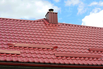 Closeup on new chimney pipe and roof protection from snow board (Snow guard) on house construction