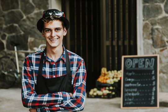 enterprising man smiling in front of business