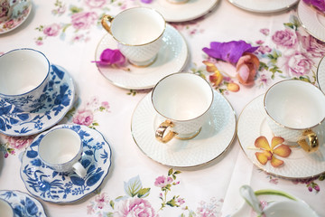 Obraz na płótnie Canvas Empty tea cup setting on the table for party - soft focus