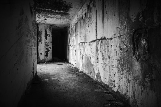 Empty abandoned bunker interior with dark end