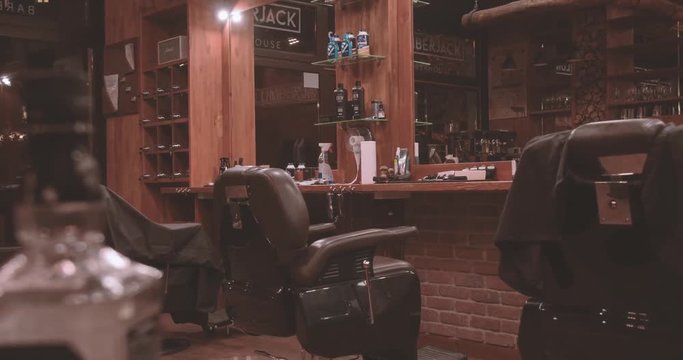 Vintage barbershop interior 4k panoramic video. Hairdressing salon in wooded retro authentic style, barber chair, mirror, whisky