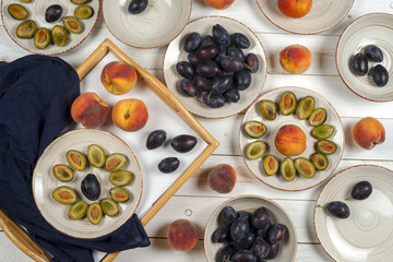 Plums on a white rustic background. Top view.