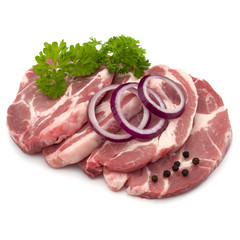 Raw pork neck chop meat with parsley herb leaves, peppercorn spi