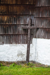 Cross leaning against the wall of the wooden church