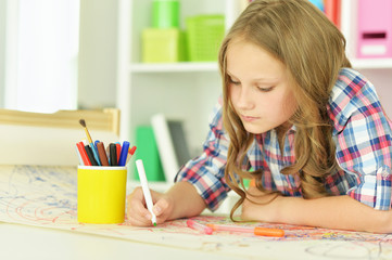 Little girl drawing at  class