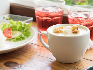 Cream soup and bread toasted on wooden table