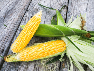 sweetcorn on wooden background.