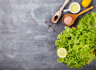 Fresh salad greens of lettuce with spices and fresh vegetables.Vegetarian and healthily cooking concept.Copy space.selective focus