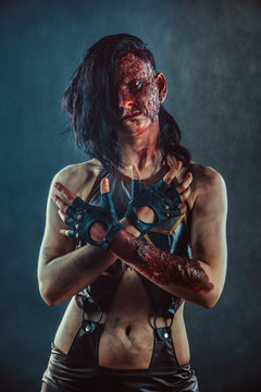 Zombie woman with the bloody face and hands.