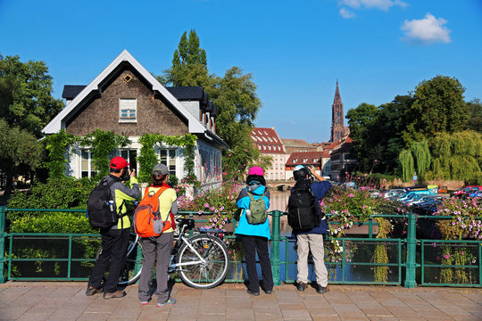 group of tourists taking photos in downtown Strasbourg - Alsace region - France