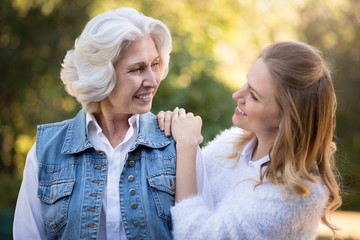 Two good looking women walking in the park.