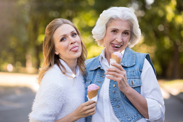Fototapeta premium Two funny women eating ice cream