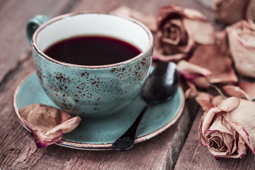 Cup of coffee and dry rose