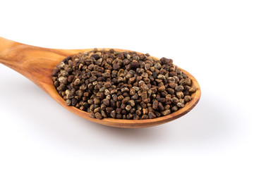 Decorticated cardamom seeds in a wooden spoon