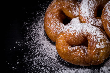 Sprinkling sugar powder on donut
