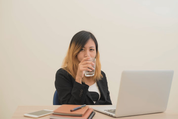 business woman  working on his laptop and drinking water.