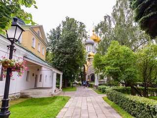 Some tourists are walking along the main path of the Novodevichy