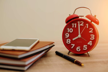 clock and notebook on the dask at office