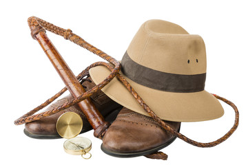 Travel and adventure concept. Vintage brown shoes with fedora hat, bullwhip and compass isolated - obrazy, fototapety, plakaty
