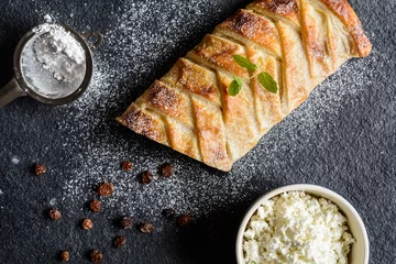  Braided strudel stuffed with curd and raisins, sprinkled with icing sugar © noirchocolate