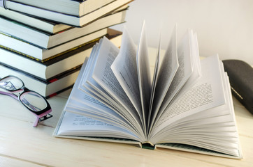 stack of books and opened book