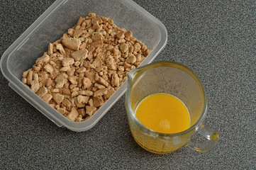 Crushed biscuits and melted butter