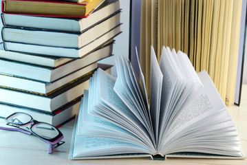 stack of books and opened book