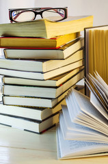 stack of books and opened book