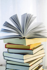 stack of books and opened book