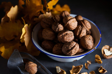 Walnuts in a bowl on a gray background