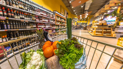 Supermarket cart filled  with healthy products