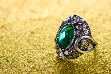 Jewellery concept with ring on shiny background