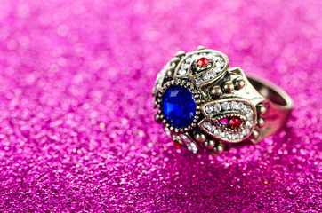 Jewellery concept with ring on shiny background